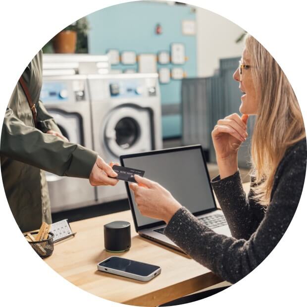 Woman accepting a credit card for payment.