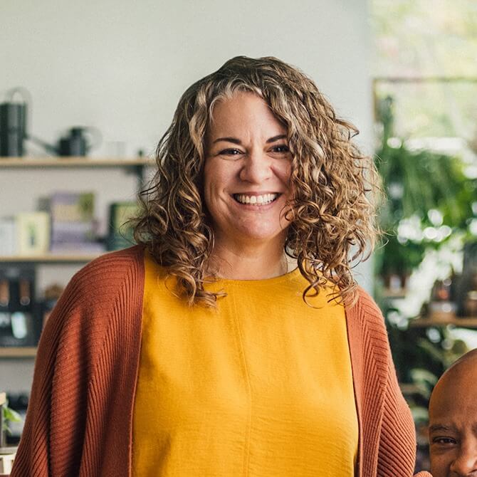 A portrait of a retail shop owners She is surrounded by home goods.