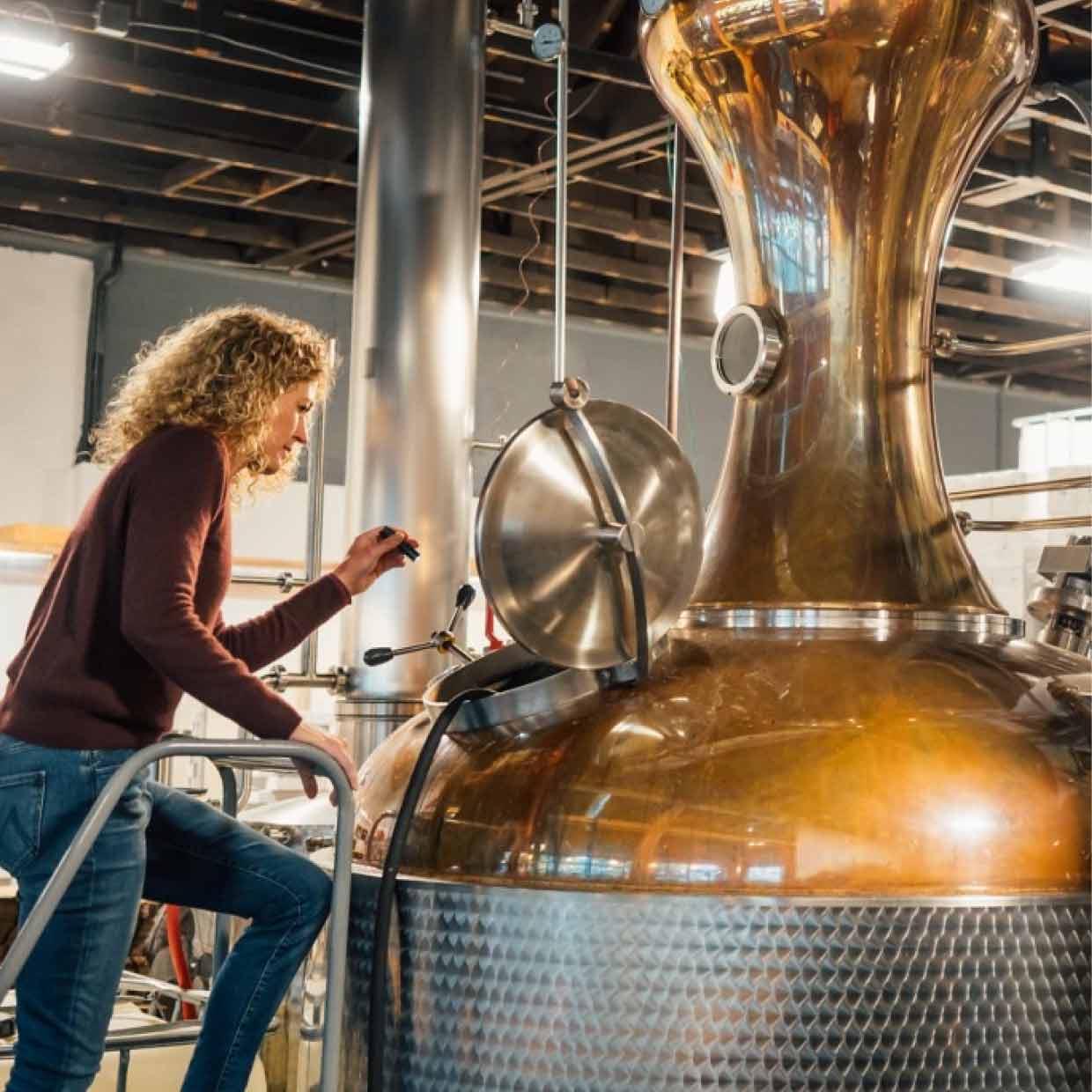 The manager of a brewery spending time inspecting the tank so it’s ready for the next batch.