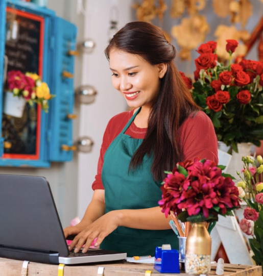 Business owners using QuickBooks accounting software on laptop.