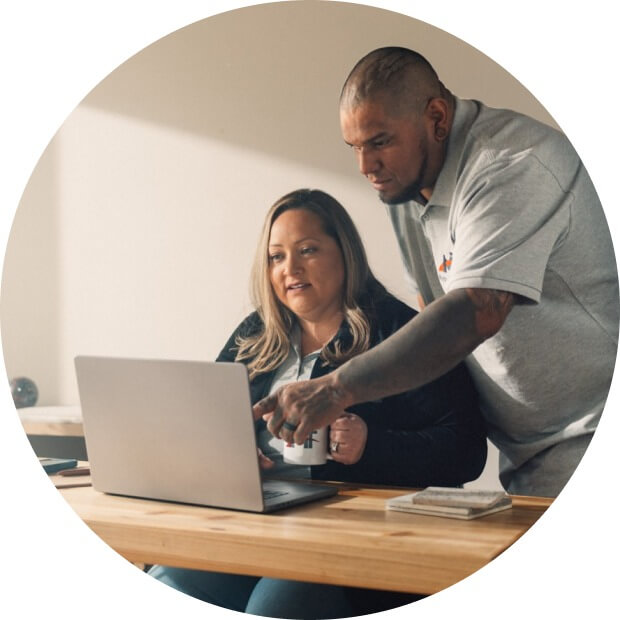 Two business owners looking over a laptop.