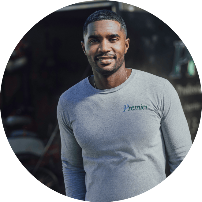 Service-based business owner smiles while looking over activities at a work site.